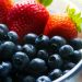 black berries served beside strawberry on clear glass bowl