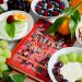 fruits on plates beside red book